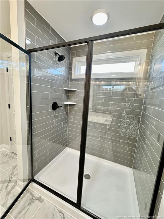 bathroom featuring plenty of natural light and an enclosed shower