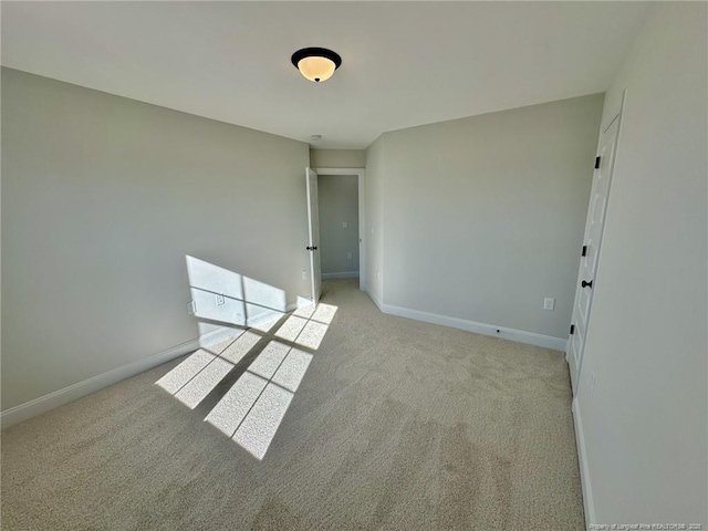 spare room with light colored carpet