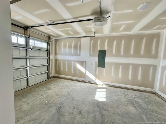 garage with a garage door opener and electric panel