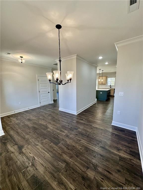 unfurnished dining area with ornamental molding, dark hardwood / wood-style floors, and a notable chandelier