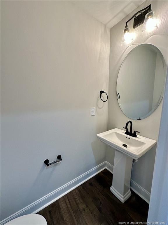 bathroom with hardwood / wood-style flooring