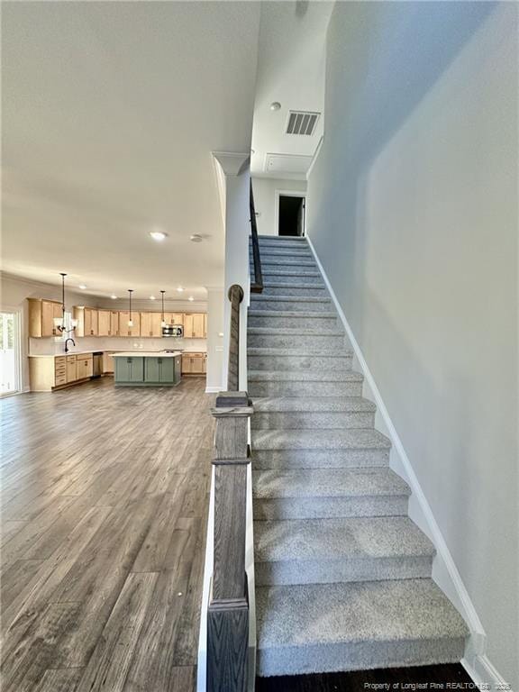 stairs with wood-type flooring