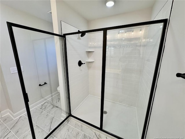 bathroom featuring toilet and walk in shower