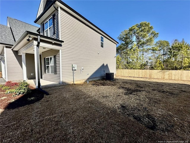 view of property exterior with central AC unit and a patio