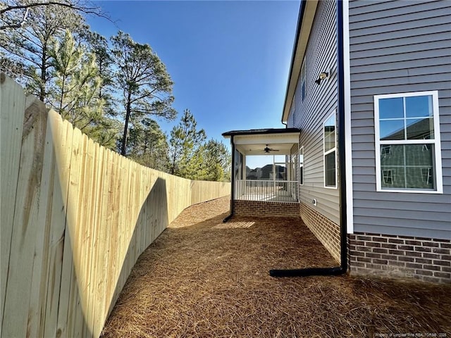 view of yard with ceiling fan