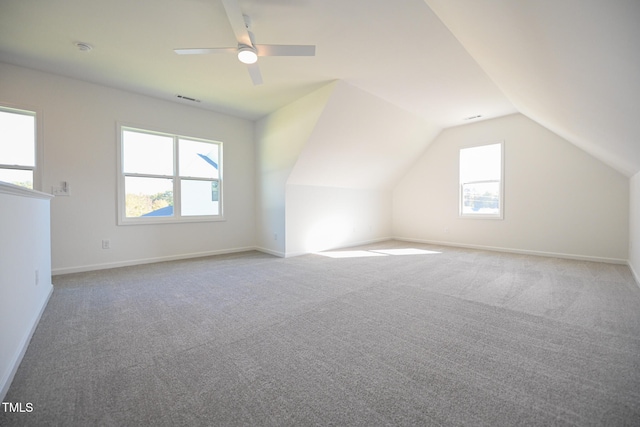 additional living space with carpet flooring, ceiling fan, and vaulted ceiling