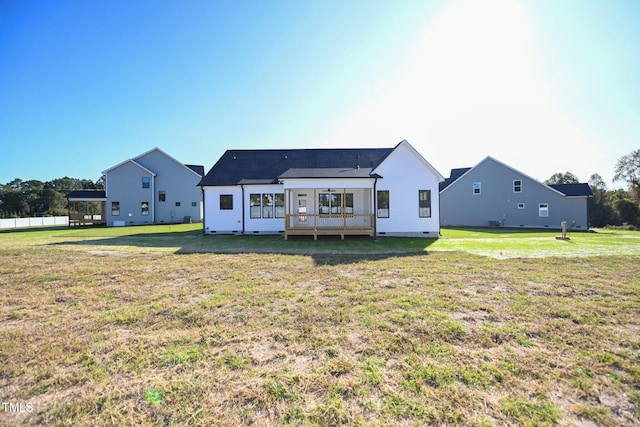 rear view of house featuring a yard