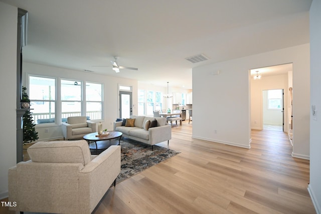 living room with light hardwood / wood-style flooring and ceiling fan