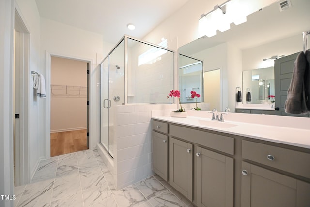 bathroom featuring vanity and an enclosed shower