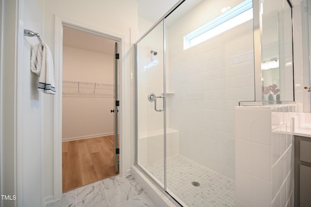 bathroom with hardwood / wood-style floors, vanity, and an enclosed shower