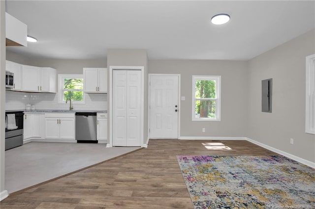 kitchen featuring appliances with stainless steel finishes, white cabinetry, and a healthy amount of sunlight