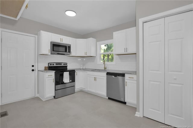 kitchen featuring sink, white cabinets, and appliances with stainless steel finishes