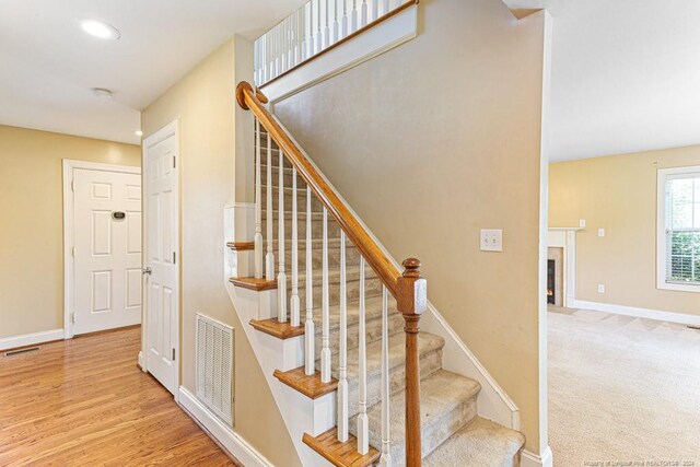 staircase with wood-type flooring