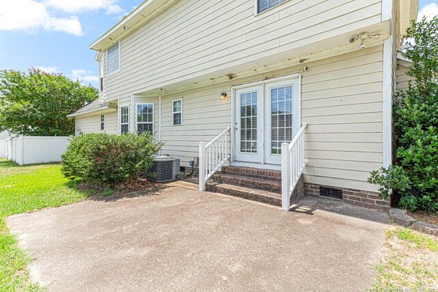 entrance to property with central AC unit and a patio area