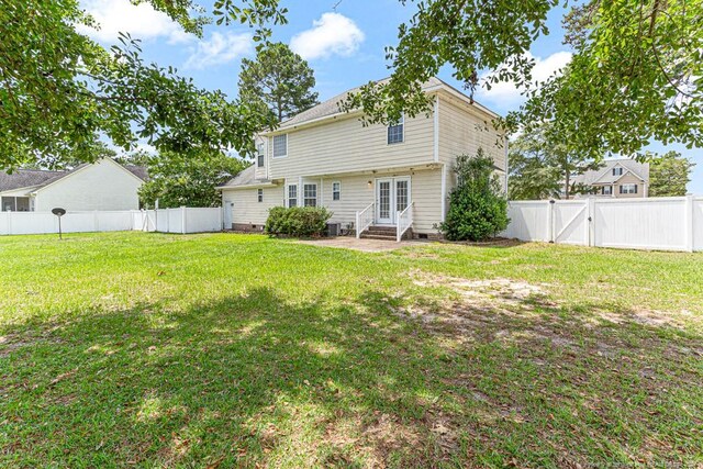 back of house with a lawn and french doors