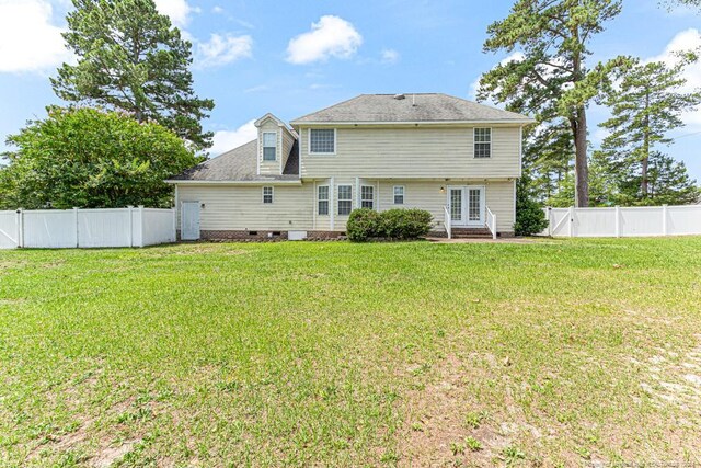 rear view of house with a yard and french doors