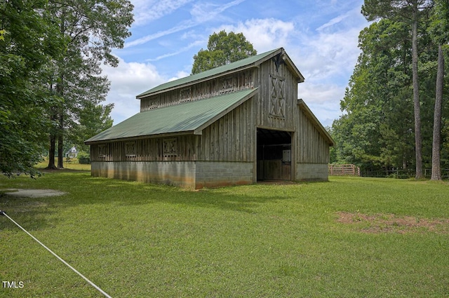 view of outbuilding featuring a lawn