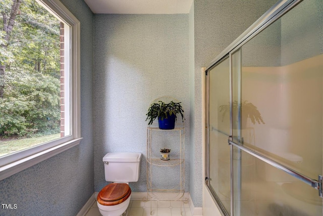 bathroom featuring toilet and walk in shower