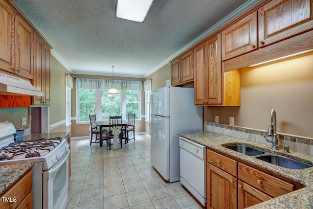 kitchen with ornamental molding, white appliances, sink, light tile patterned floors, and decorative light fixtures