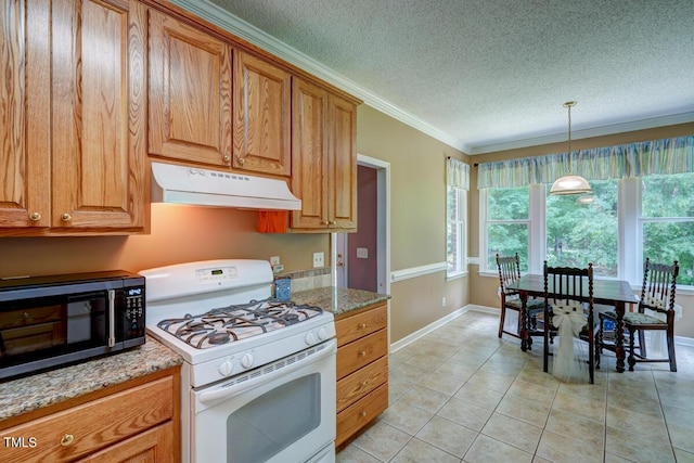 kitchen with hanging light fixtures, light stone countertops, white gas range, ornamental molding, and light tile patterned floors