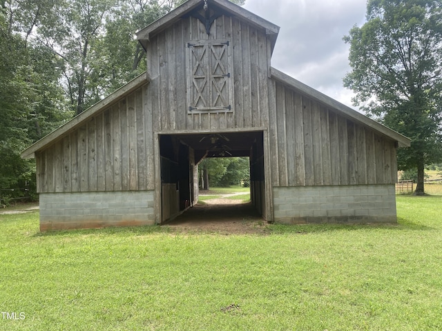 view of outbuilding featuring a yard