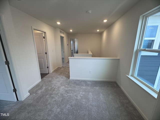 unfurnished room with dark carpet