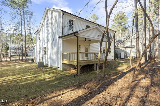 back of house with ceiling fan, a yard, a deck, central AC, and a porch