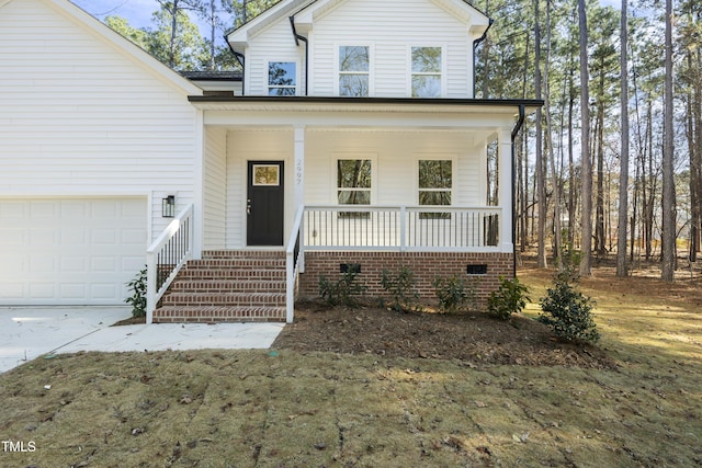 view of front of home featuring a porch and a garage