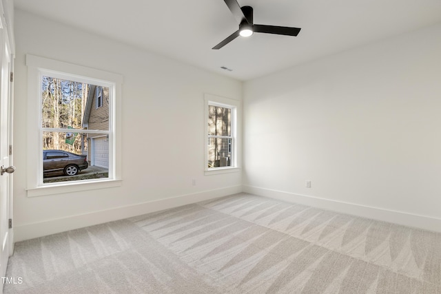 spare room featuring ceiling fan and light colored carpet