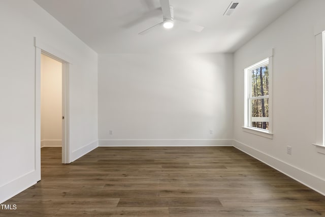 unfurnished room with ceiling fan and dark wood-type flooring