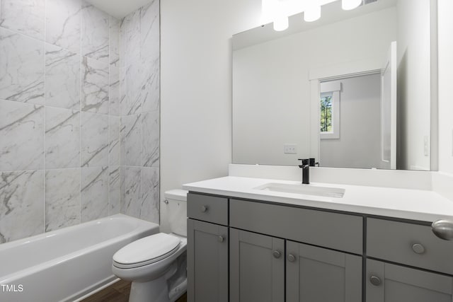 full bathroom featuring vanity, toilet, and tiled shower / bath