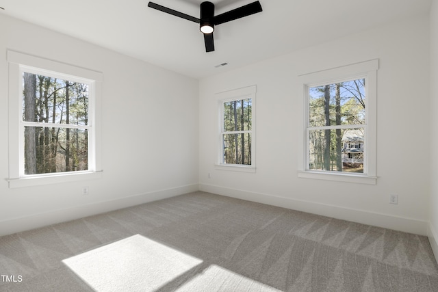 carpeted empty room featuring ceiling fan