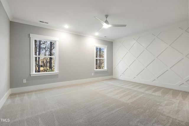 carpeted empty room with crown molding and ceiling fan