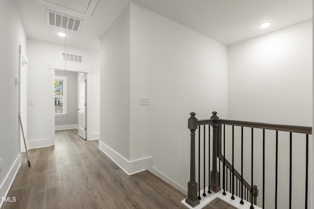 hallway with hardwood / wood-style flooring