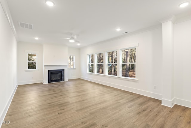 unfurnished living room featuring light hardwood / wood-style flooring, ceiling fan, and ornamental molding