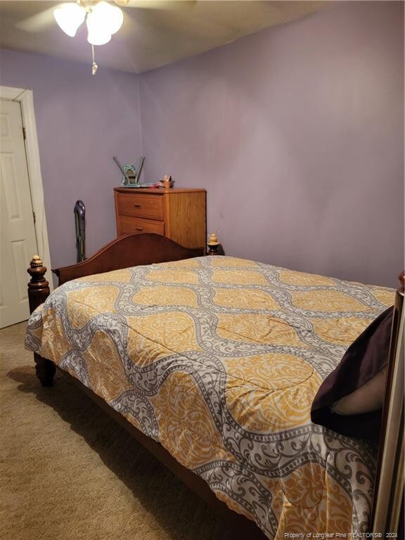 bedroom featuring ceiling fan and carpet floors