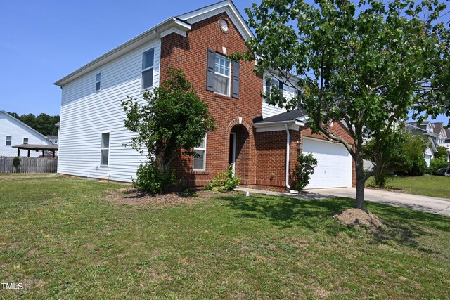 view of front of house with a garage and a front lawn