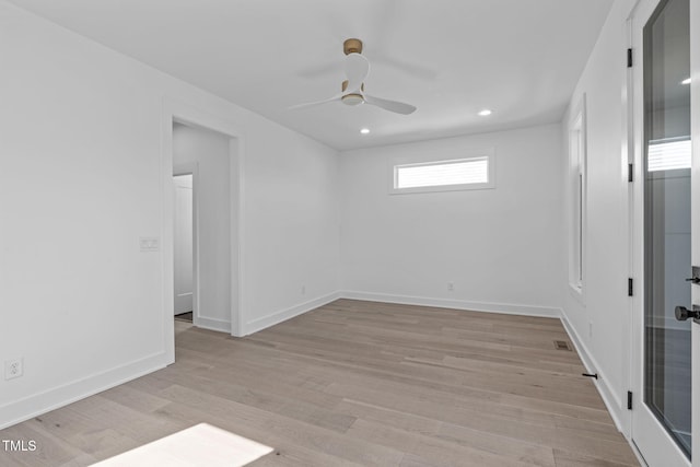 empty room with light wood-type flooring, baseboards, a ceiling fan, and recessed lighting