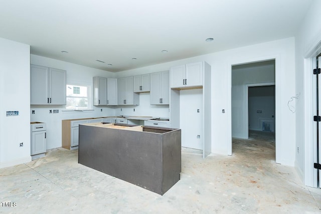 kitchen with a kitchen island and gray cabinets