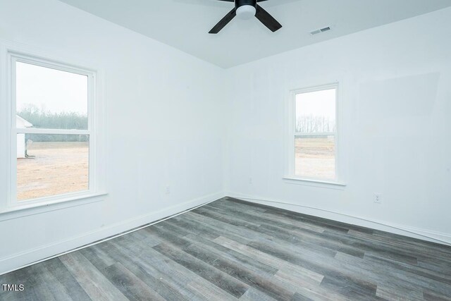 unfurnished room featuring visible vents, ceiling fan, baseboards, and wood finished floors