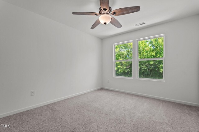 empty room with carpet flooring and ceiling fan