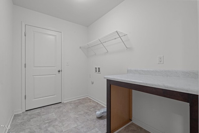 clothes washing area with hookup for a washing machine and light tile patterned floors