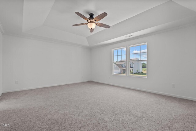 carpeted empty room featuring ceiling fan and a tray ceiling