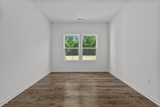 unfurnished room featuring hardwood / wood-style flooring