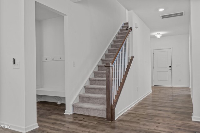 stairs featuring hardwood / wood-style flooring