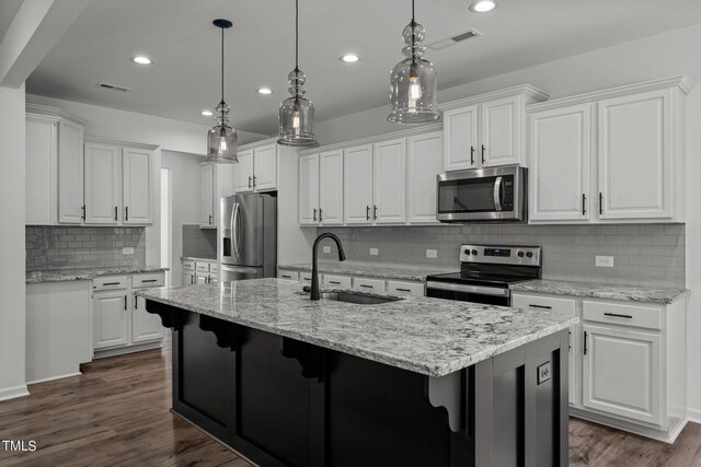 kitchen featuring dark hardwood / wood-style flooring, tasteful backsplash, and stainless steel appliances