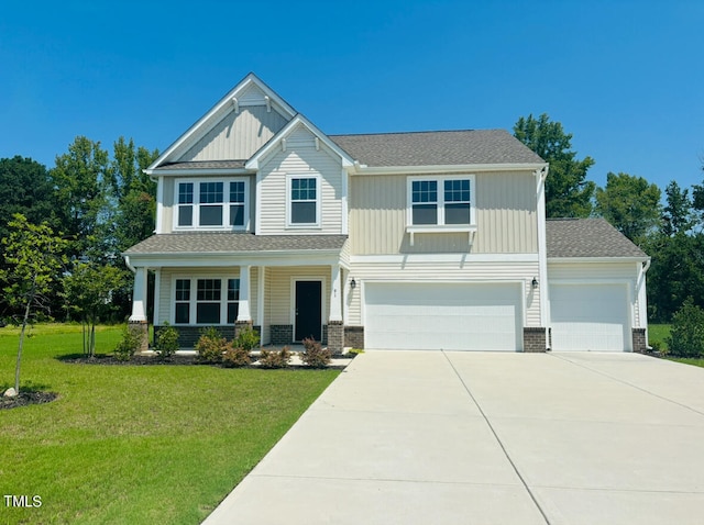 craftsman inspired home featuring a garage and a front lawn