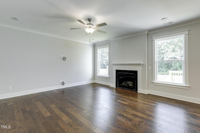 unfurnished living room featuring crown molding, plenty of natural light, and dark hardwood / wood-style flooring