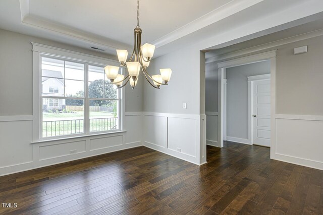 unfurnished dining area with ornamental molding, dark hardwood / wood-style floors, and a chandelier