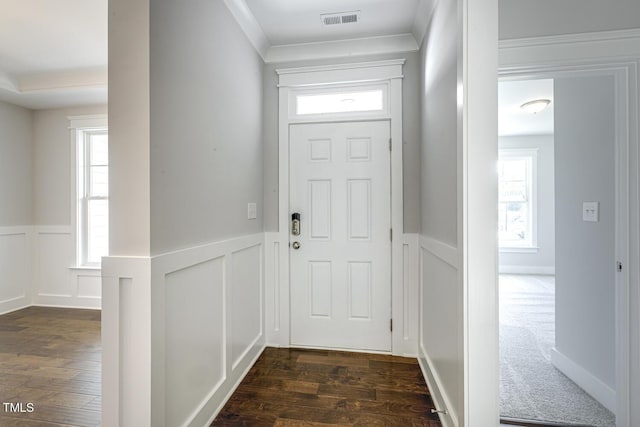 entryway with crown molding and dark hardwood / wood-style floors